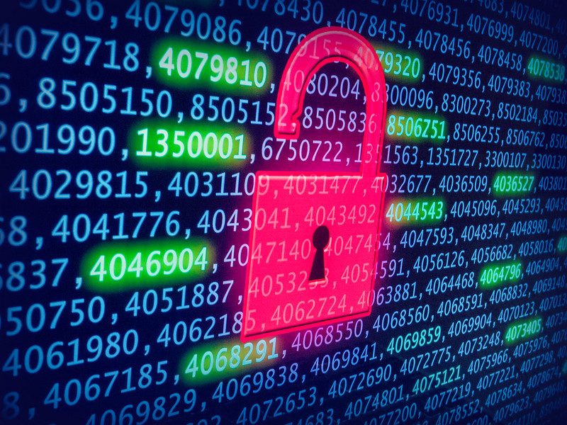 Image of a red padlock unlocked over a computer screen with binary code covering it to illustrate a data breach and data breach notification trigger in Australia