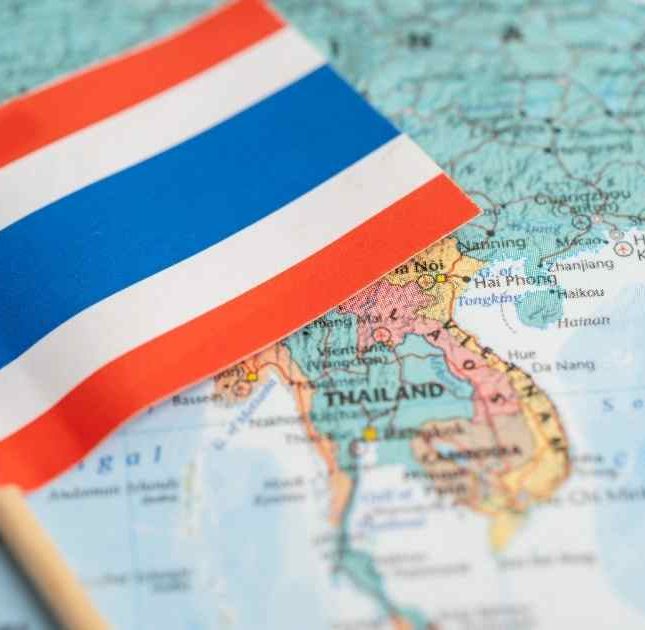 Thai flag on top of a map of Thailand