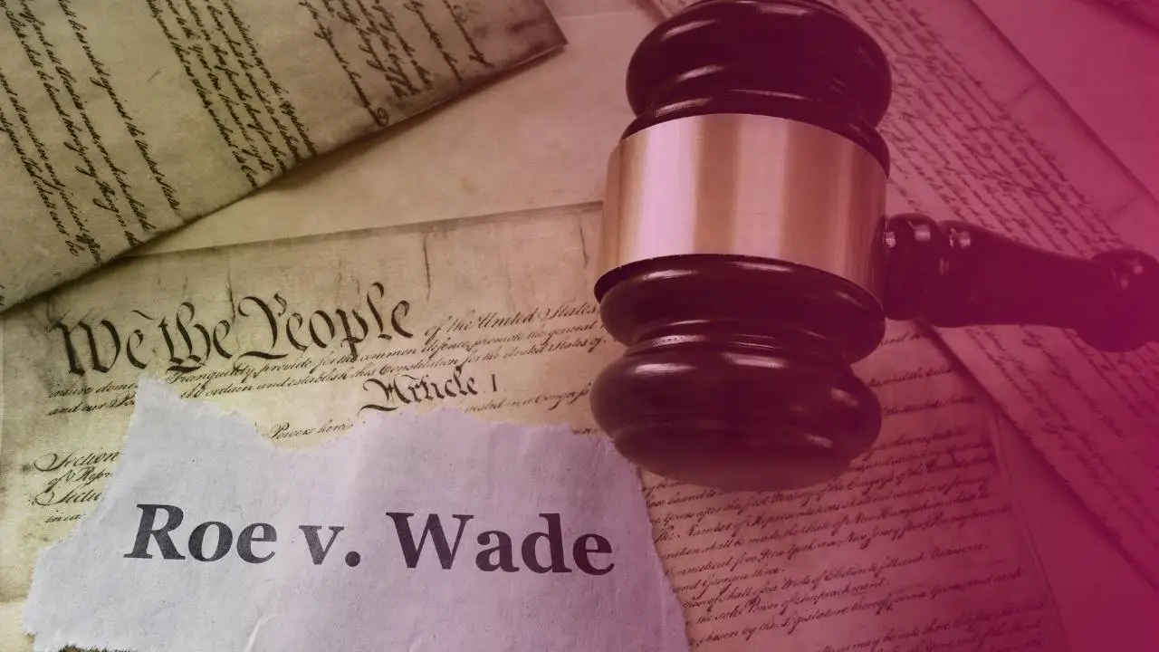 Photograph of a judge's gavel laying on a copy of the Roe v Wade judgement text